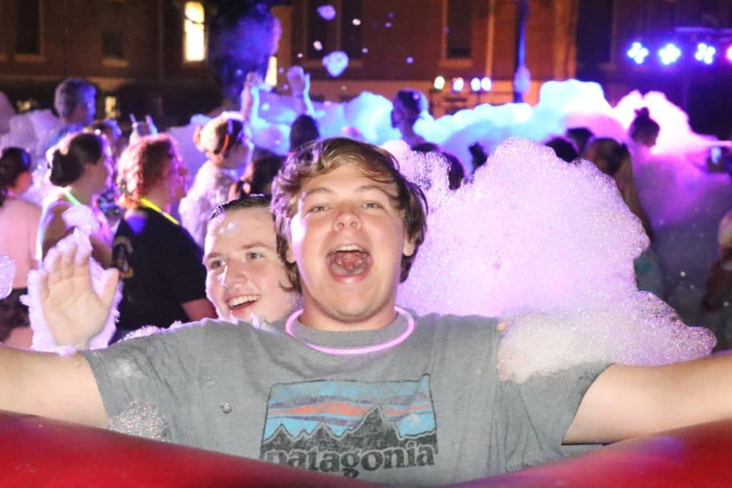 A group of people at a party with soap bubbles organized by the Common Activities Board.
