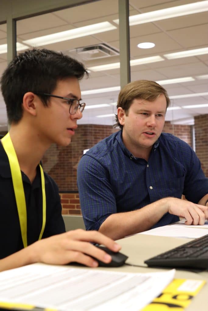 A man working on a computer for transfer admissions.