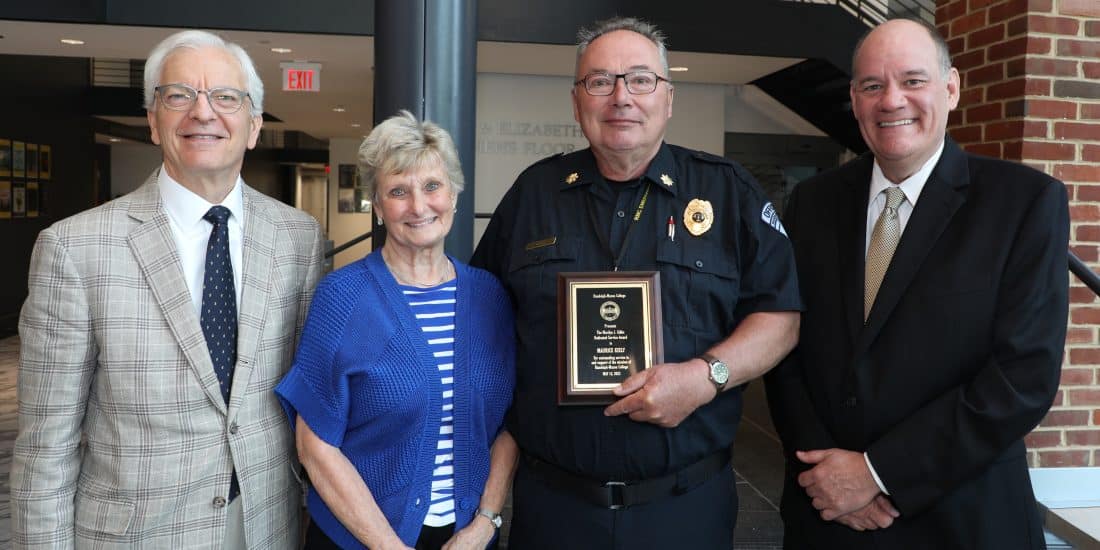 Maurice Kiely stands with President Lindgren, Dean Azdell, and Marilyn Gibbs holding a plaque for the Marilyn J. Gibbs Dedicated Service Award