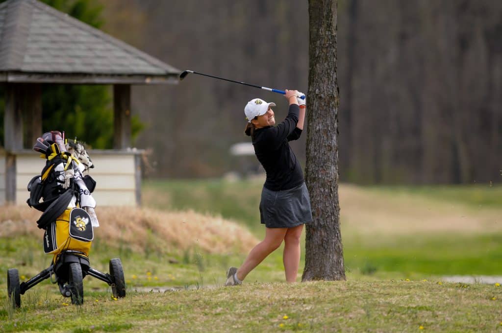Moriconi Tracy '16 is swinging a golf club.
