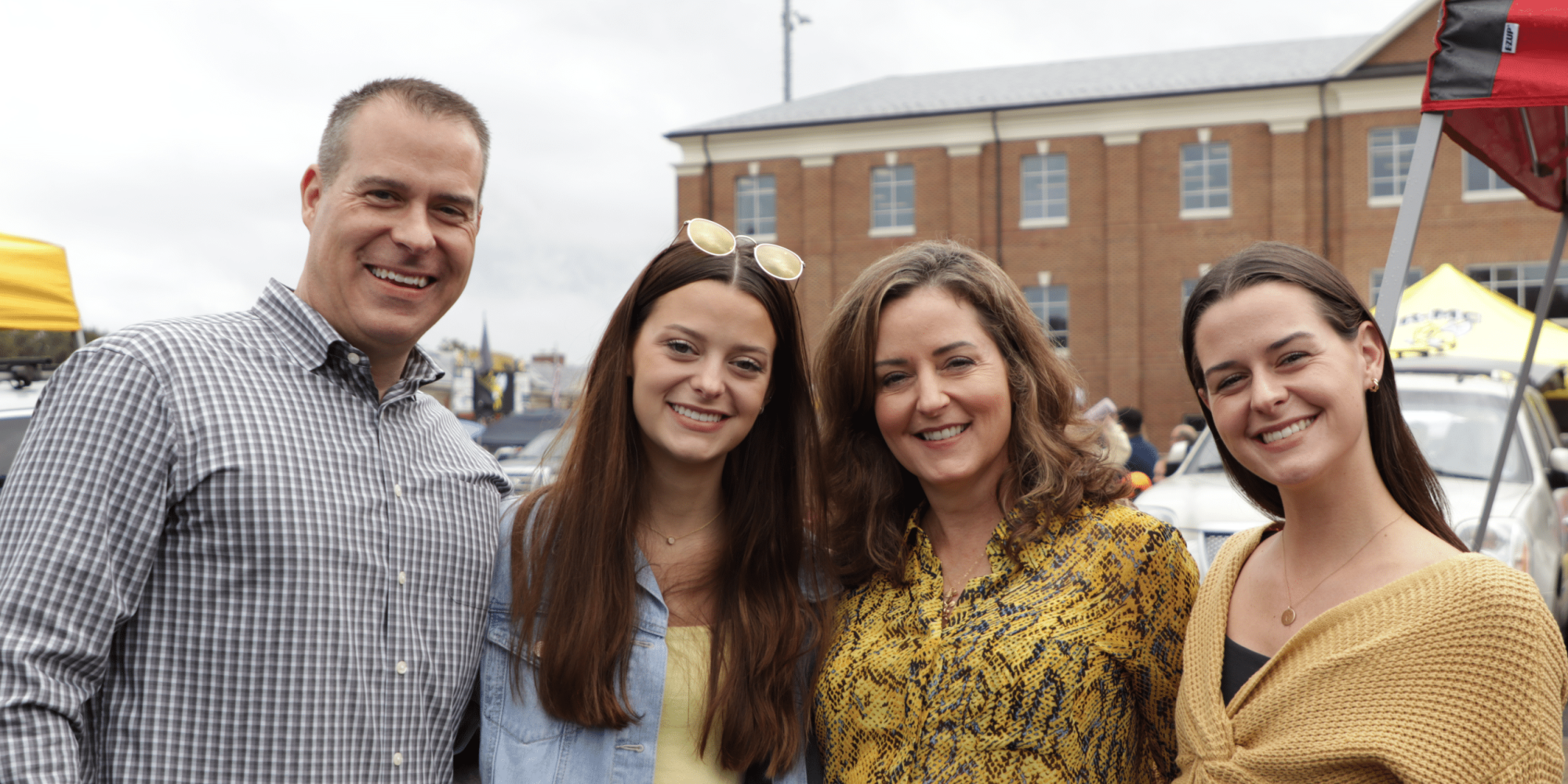 4 people who appear to be a family smiling