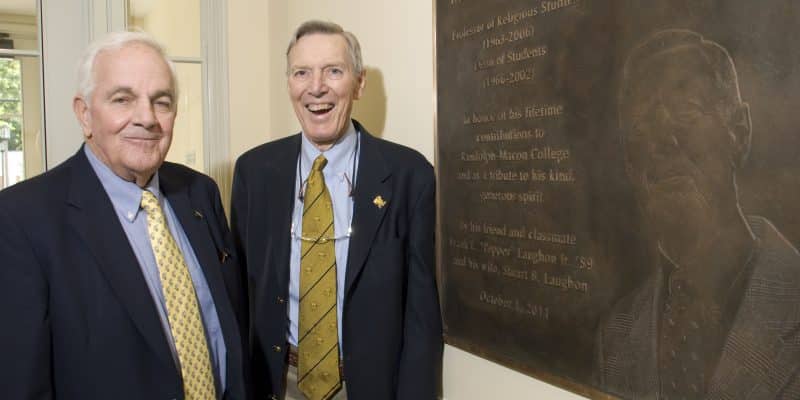 Pepper Laughon and Ira Andrews standing next to a plaque