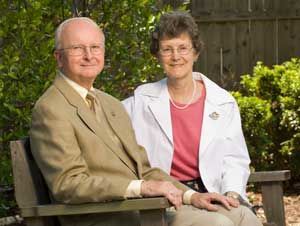 Peter and Maria Rippe sitting on a wooden bench.