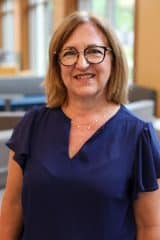 A woman in blue top.