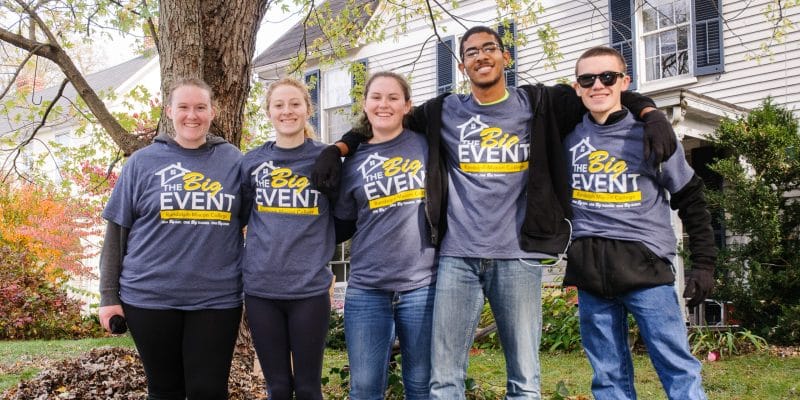 Students posing for a picture wearing big event t shirts