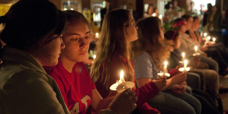 Students holding candles at a vigil