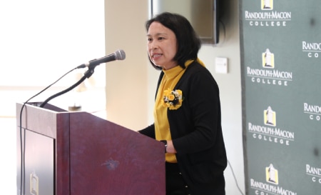 Dr. Lim-Fong speaking at a podium