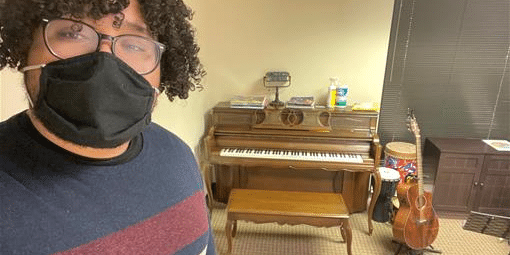 Eduardo Moreno stadning in front of a piano