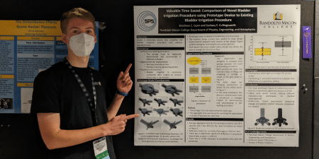 Matt Gunn '24 poses with his winning research poster at the 2022 Physics Congress