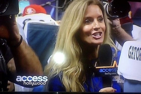 A tv screen with a Leigh Oblinger talking to the camera.