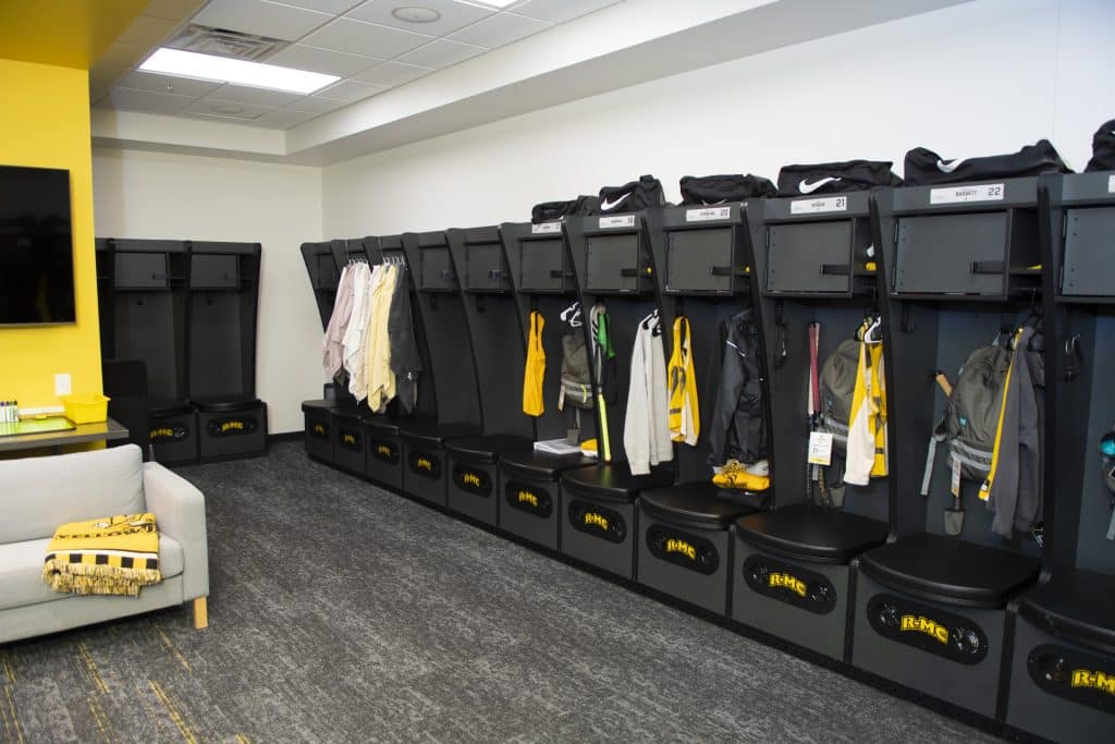 A locker room in Duke Hall that is decorated in lemon yellow and black