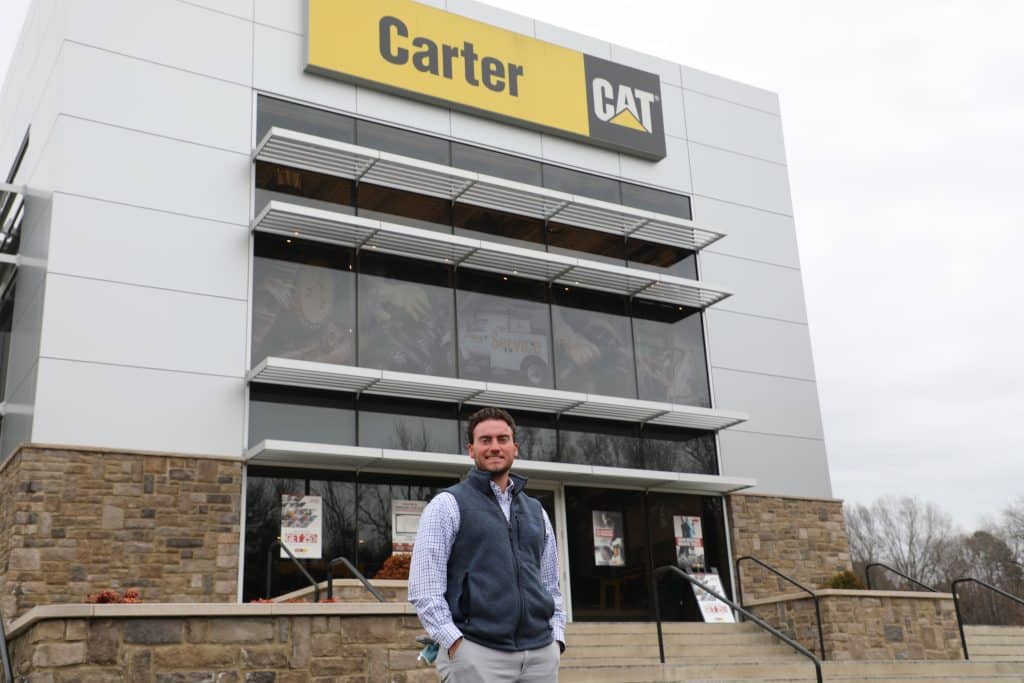 A man standing in front of a cat store.