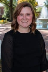 Jordyn Kilmer smiling in front of a fountain.