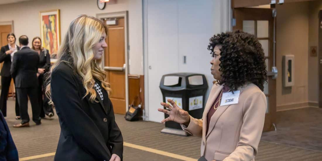 Joy Asekun speaks with a student at the Edge Boot Camp