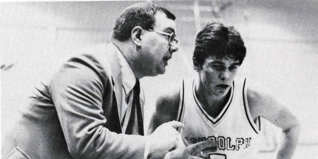 Hal Nunnally coaching a Randolph-Macon basketball player during a game.