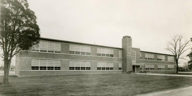 A black and white photo of a high school building.