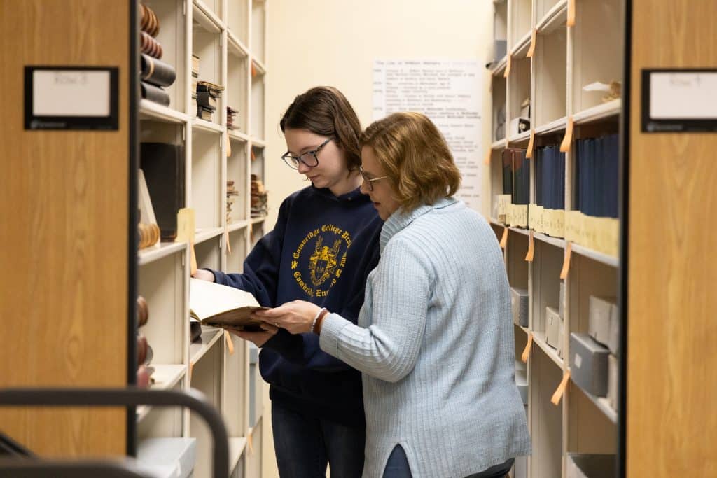 Kait Priest works with her J-Term supervisor at the archives for the Virginia United Methodist Conference.
