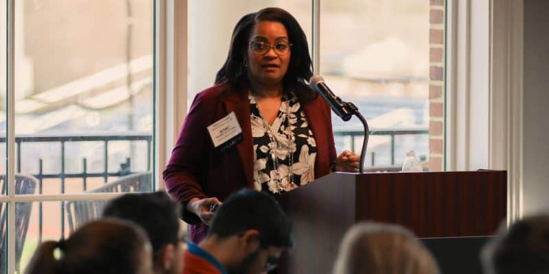 A woman giving a speech at a podium.