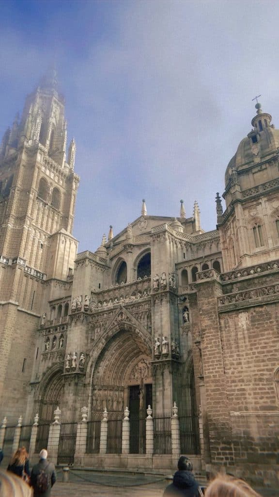 A group of people standing in front of a cathedral.