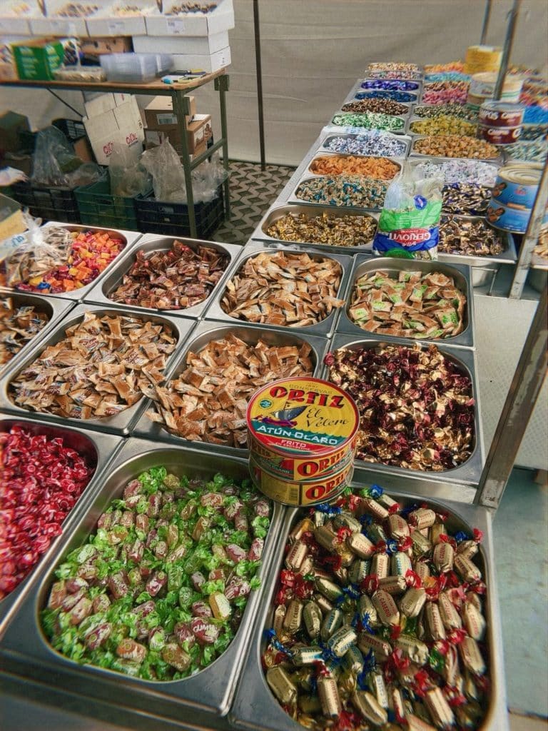 A table with many different kinds of Spanish candy.