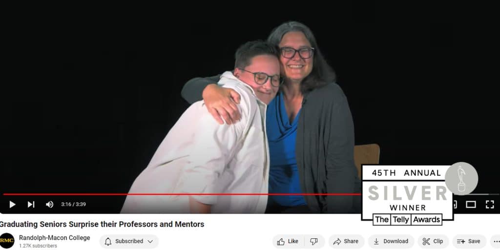 Screenshot of YouTube page with student hugging staff member