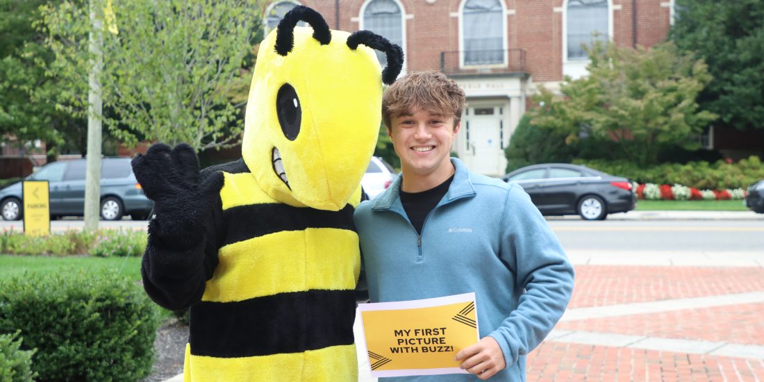 Prospective student first photo with Buzz at RMC's Preview Day.