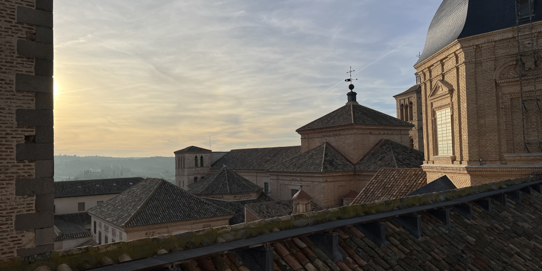 During sunset, a view of the historic church with multiple domes and rooftops captures the essence of Hispanic culture, as weathered brickwork contrasts beautifully with a partly cloudy sky.
