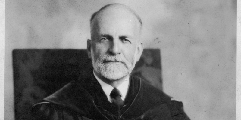 A black-and-white, seated portrait of Robert Blackwell, former President of Randolph-Macon College, wearing a shirt and tie and academic regalia.