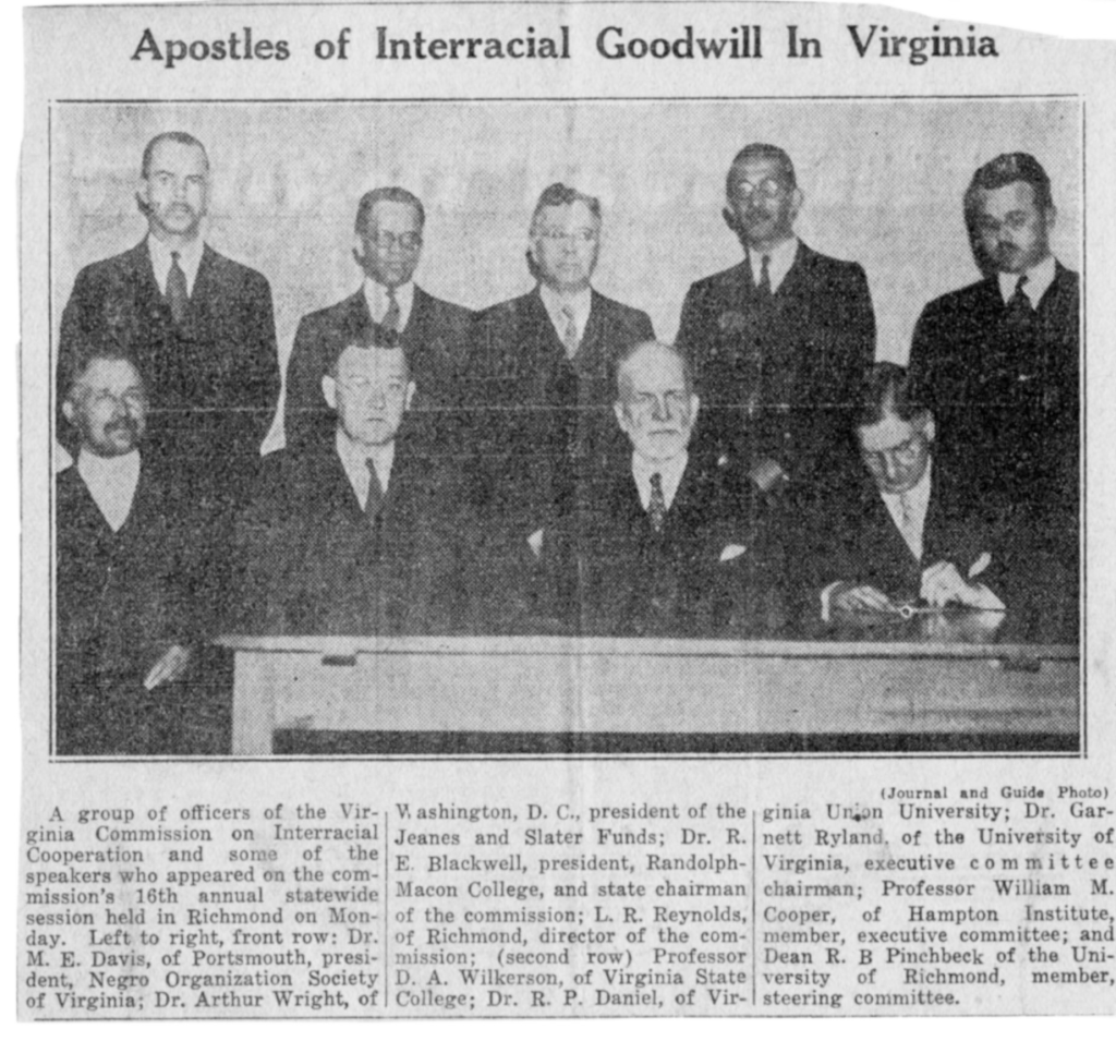 Black and white photo of eight men in suits, seated and standing, identified as members and speakers at an interracial cooperation meeting in Virginia. Title: "Apostles of Interracial Goodwill In Virginia.