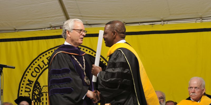 Paul Sekyere-Nyantakyi receives an honorary degree diploma during a Randolph-Macon graduation ceremony.