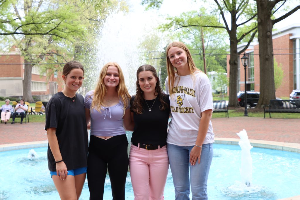 Admitted students pose in front of the fountain during an admissions event.