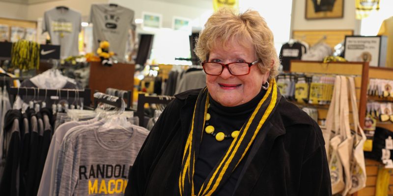 Barclay DuPriest stands in the RMC campus store with Randolph-Macon apparel on display.