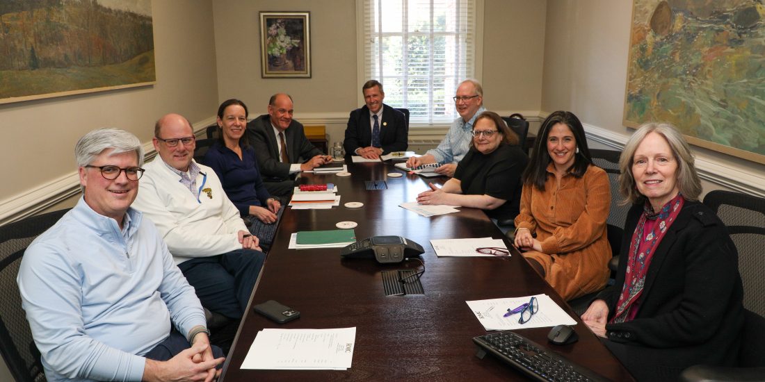 RMC cabinet seated around a conference table