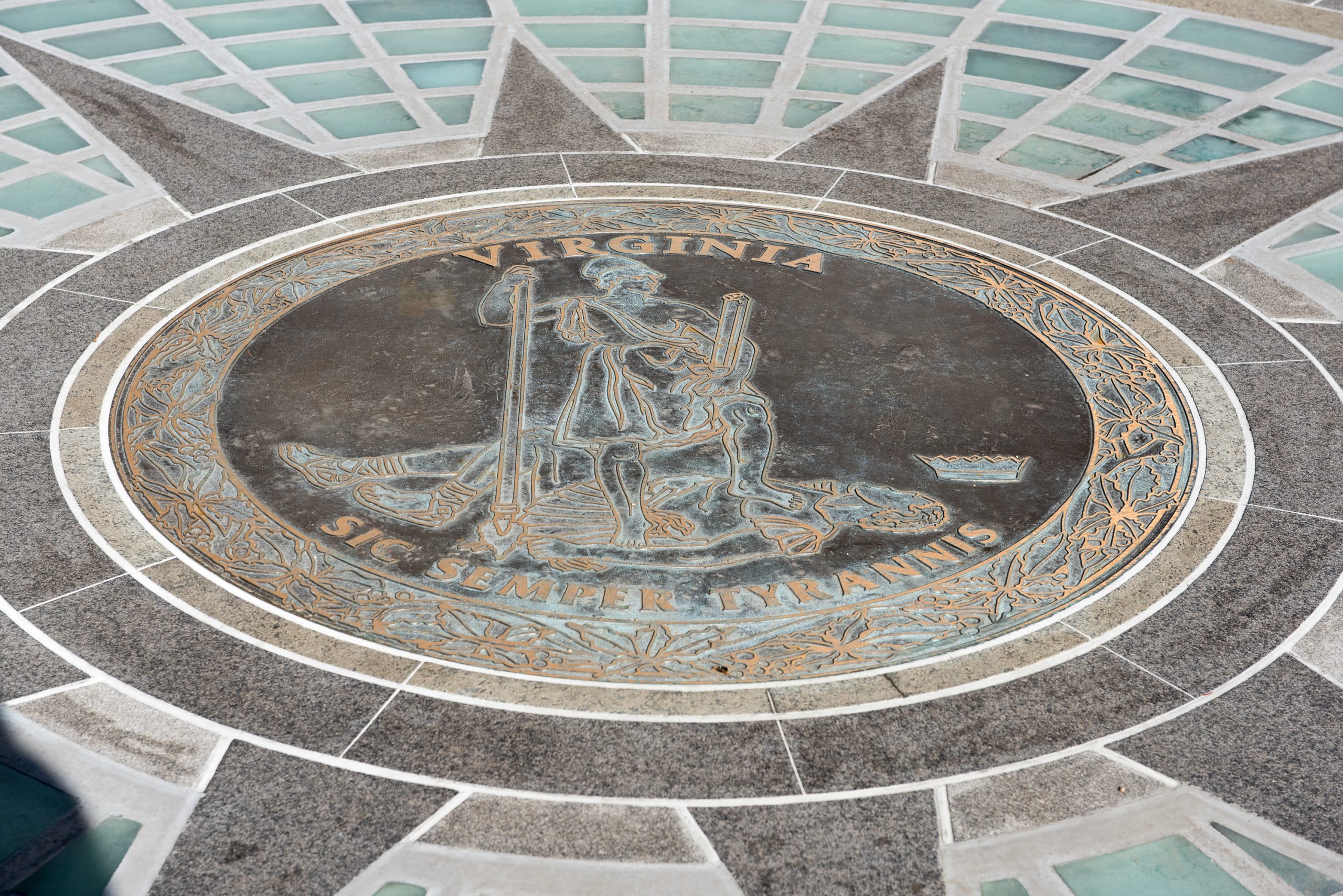The Great Seal of Virginia with the motto "Sic Semper Tyrannis" is engraved on a floor medallion at the Capitol.