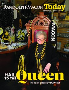 Individual seated on a large chair surrounded by Randolph-Macon College merchandise. Magazine cover reads, "Hail to the Queen.
