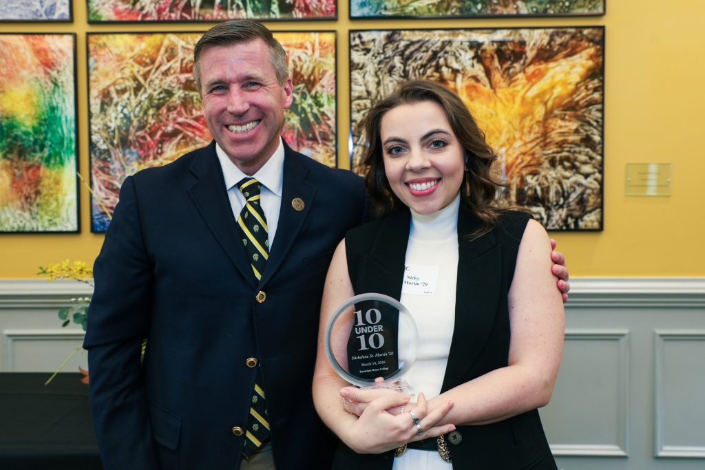 Nicholette St. Martin stands with RMC President Michael Hill, holding a 10 Under 10 award