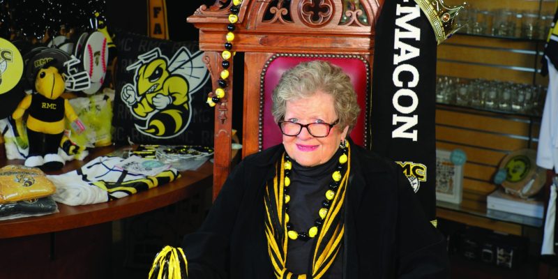 Barclay DuPriest sits on a throne inside the Randolph-Macon campus store