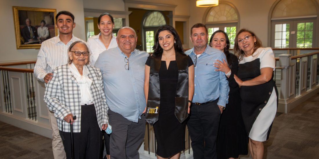 A graduate of Randolph-Macon poses with her family while wearing a first-gen stoll