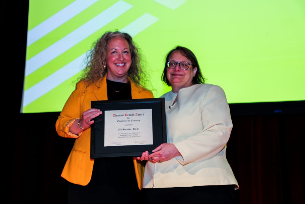 Dr. Jill Horohoe and Provost Alisa Rosenthal stand on the Blackwell stage holding a certificate