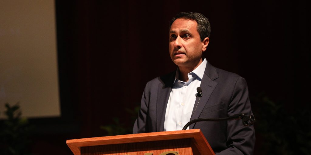 Dr. Eboo Patel stands at a podium in Blackwell Auditorium to deliver the Ira Andrews Lecture