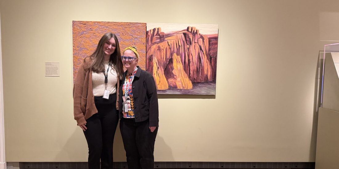 Milly Mach and Katie Domurat pose together in front of paintings at the VMFA