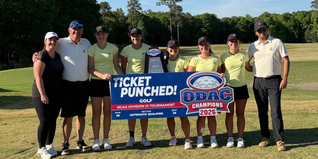The Randolph-Macon Women's Golf team stands on a golf course with its coaches holding the ODAC Championship trophy and a sign that says "ticket punched!"