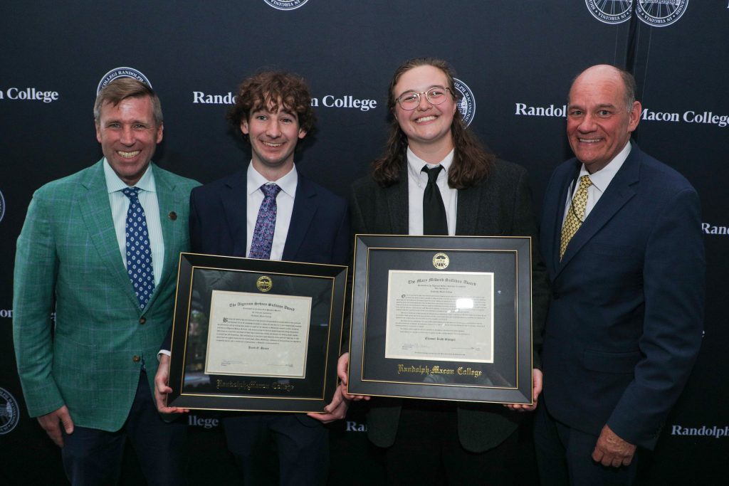 Jacob Hanes and Ella Swager, the winners of the 2026 Algernon Sydney Sullivan Awards, pose with President Hill and Dean Azdell while holding their certificates