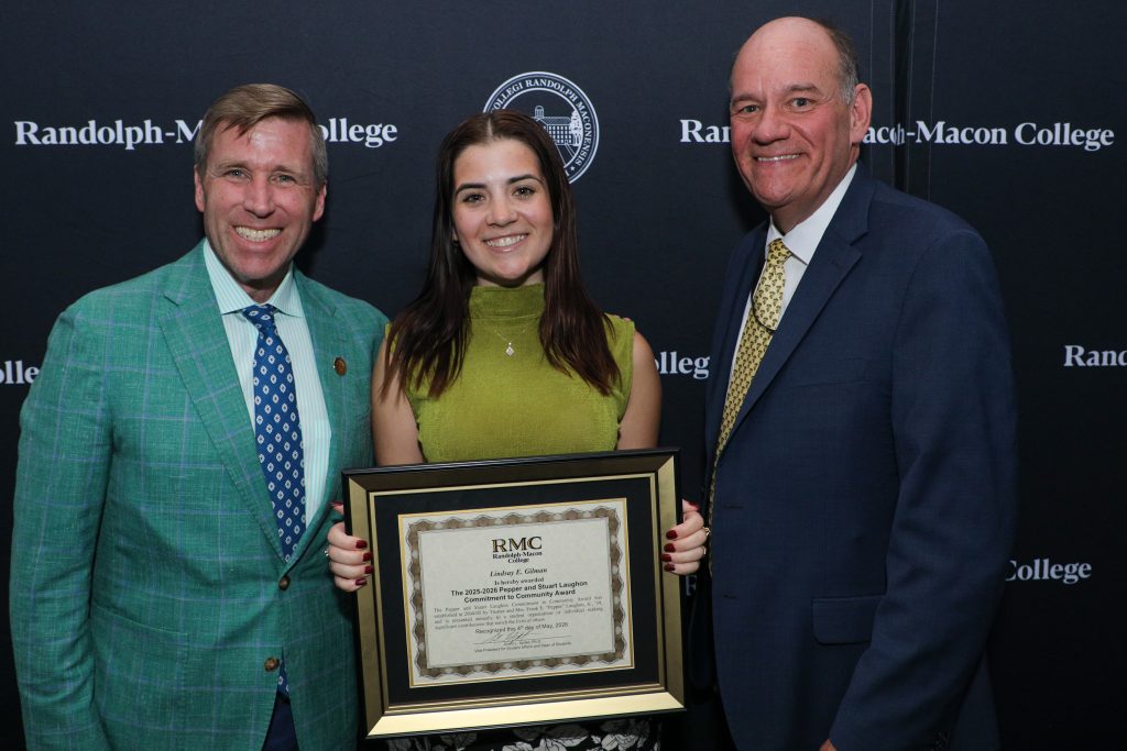 Lindsay Gilman poses with President Hill and Dean Azdell holding the Laughon Commitment to Community Award plaque