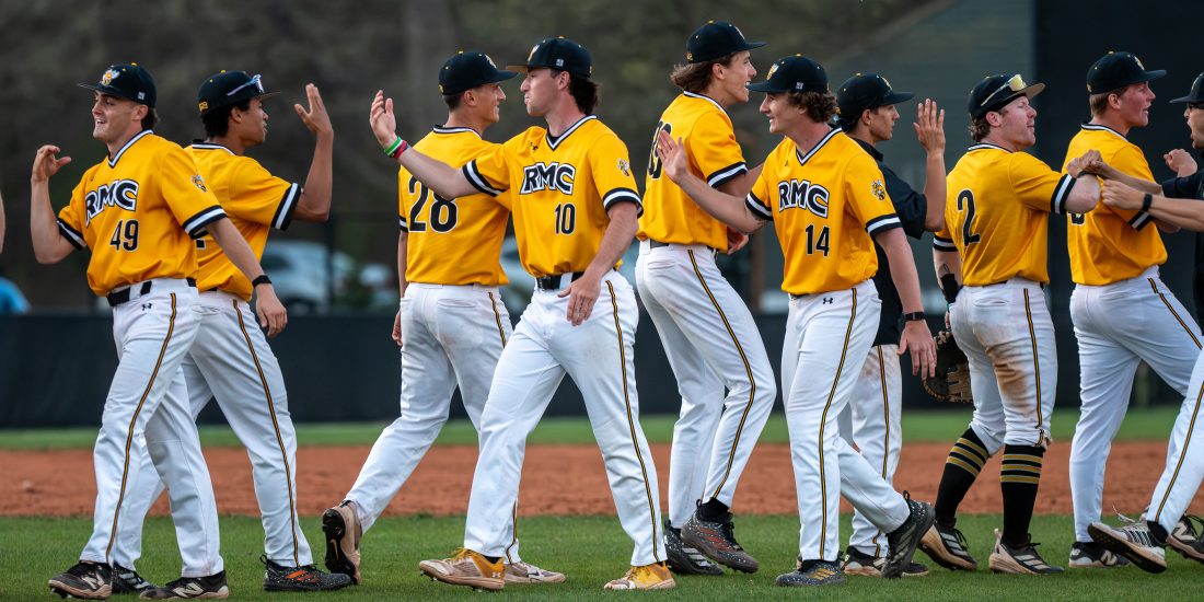 RMC Baseball players high five each other after a win