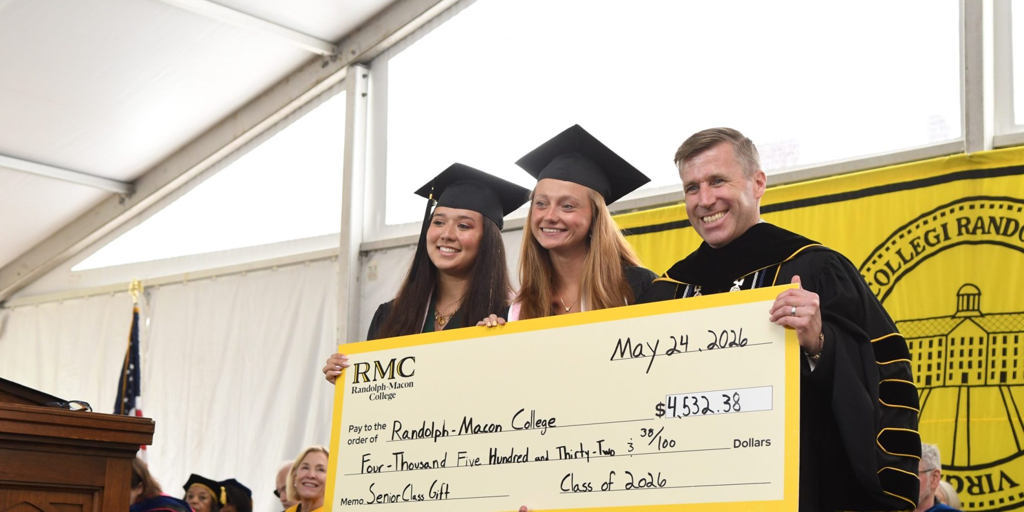Class of 2026 Senior Class Gift Chairs presenting the Big Check to Dr. Hill at Commencement