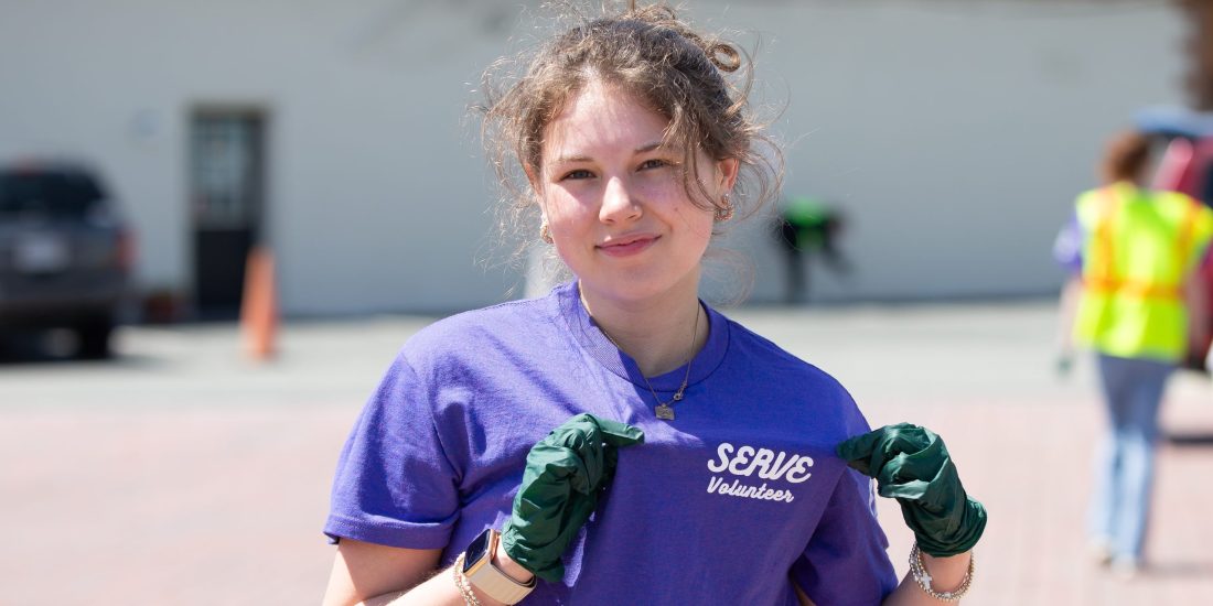 RMC student points at her T-shirt that reads 'Serve Program'