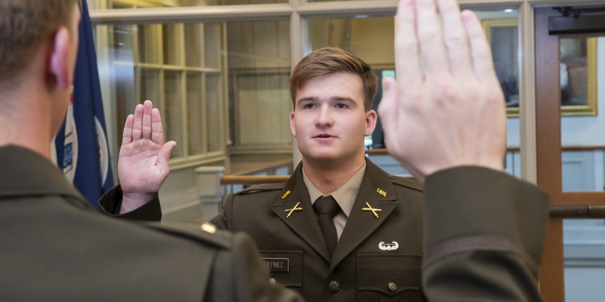 A student is sworn in to the ARMY as part of the commencement.