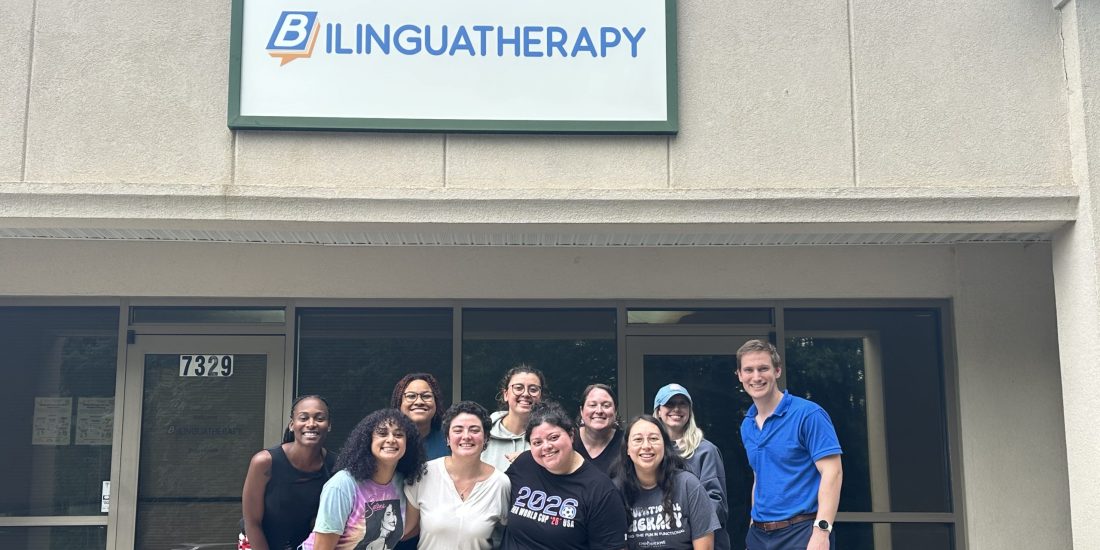 Valentina Ambrogi-Torres poses with her colleagues in front of the front entrance to Bilinguatherapy