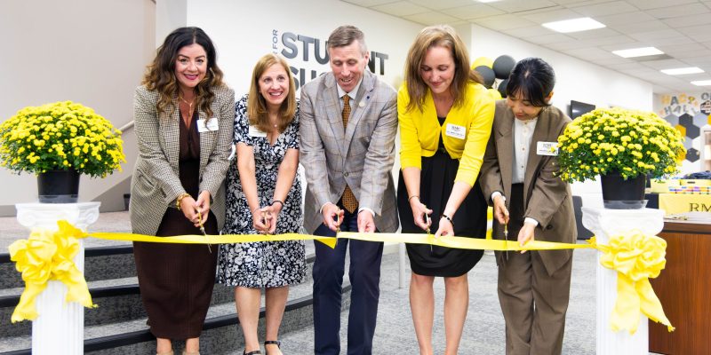 Officials cut a ribbon inside the McGraw-Page Library to signify the opening of the Center for Student Success